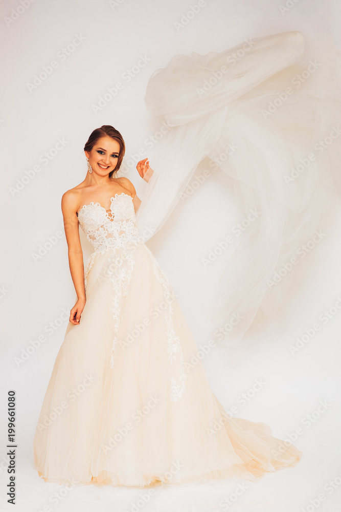 beautiful young bride in a wedding dress demonstrates different poses beautiful young bride in a wedding dress demonstrates different poses