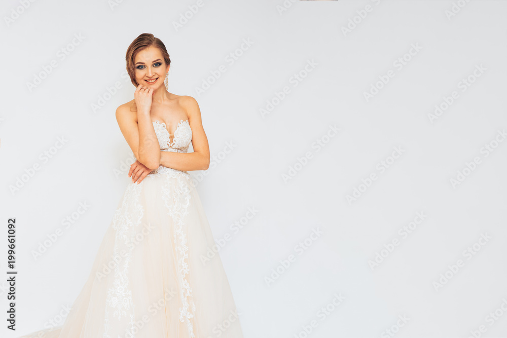 beautiful young bride in a wedding dress demonstrates different poses beautiful young bride in a wedding dress demonstrates different poses