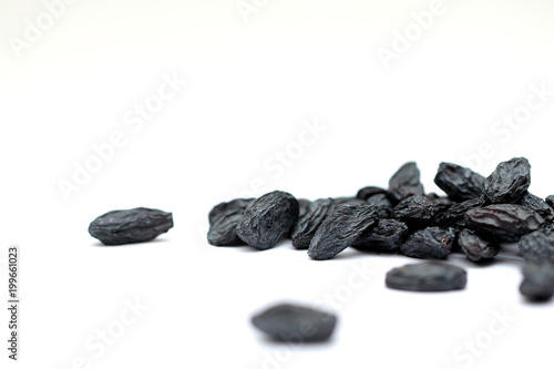 black raisins on white background