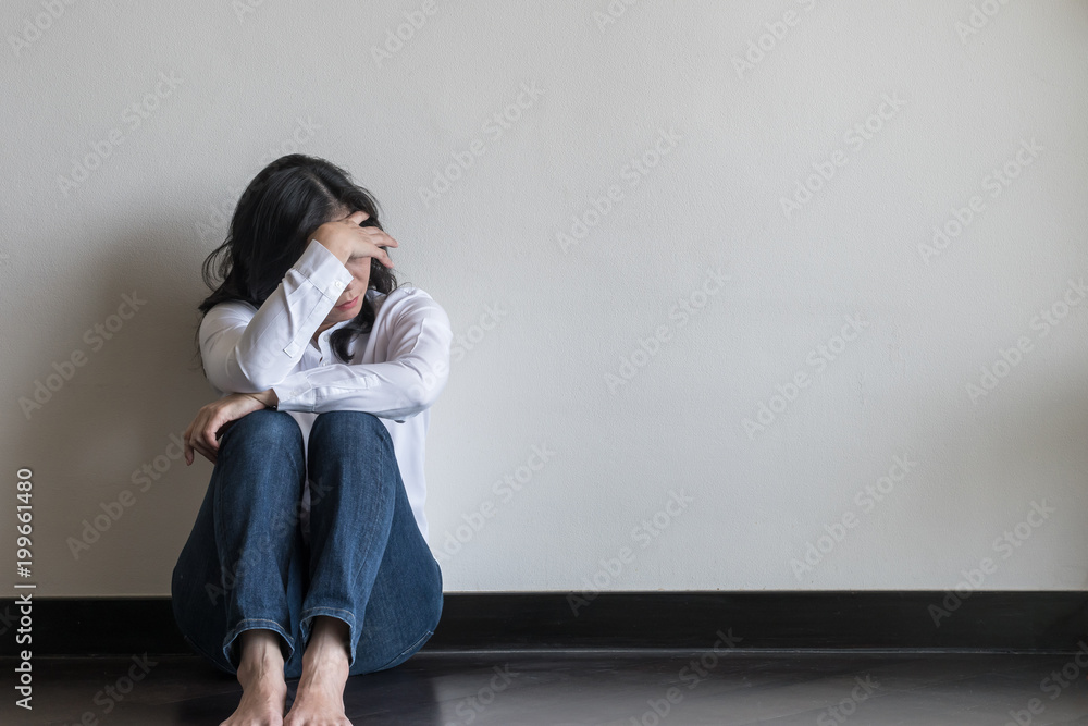 Panic attack, anxiety disorder menopause woman, stressful depressed emotional person with mental health illness, headache and migraine sitting back against wall on the floor in domestic home - obrazy, fototapety, plakaty 