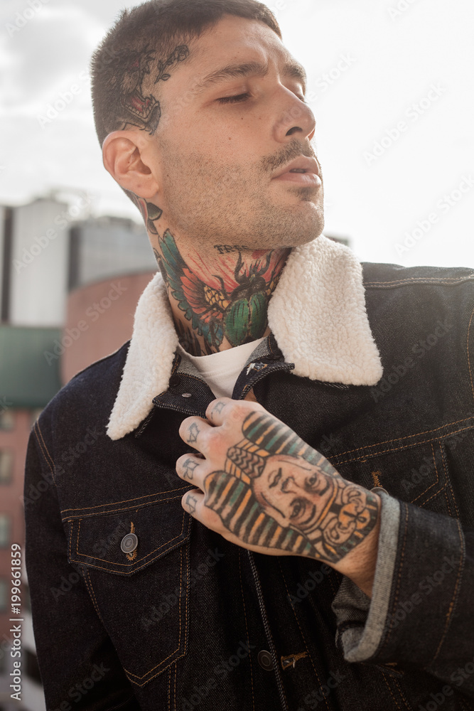Handsome man with tattoos on hand and neck Stock Photo | Adobe Stock Handsome man with tattoos on hand and neck Stock Photo | Adobe Stock