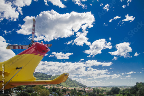 helicopter tail rotor and blue sky with clouds
