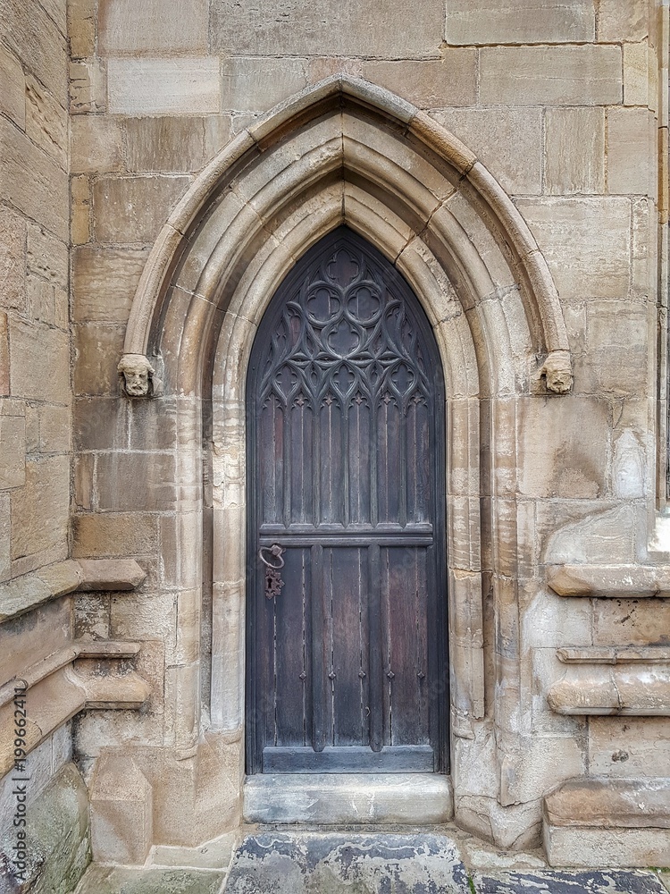 A side door of a Cathedral, with decorative carved woodwork. 