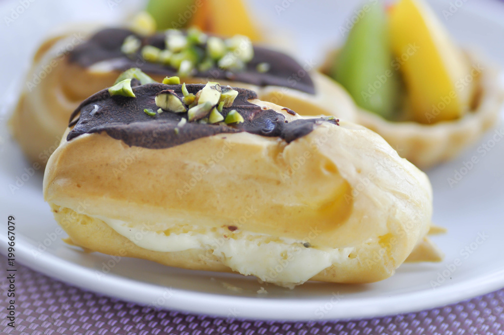 choux pastry with chocolate and pistachio topping or eclair choux pastry with chocolate and pistachio topping or eclair