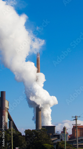 Steam and smoke coming out of a smoke stack