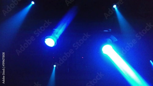 Two projectors on the ceiling of the techno club blink and rotate