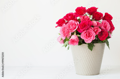 Fototapeta Naklejka Na Ścianę i Meble -  beautiful red rose flowers bouquet in vase over white