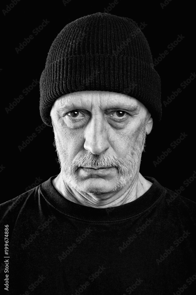 Dramatic blDramatic black and white photo of a strong man with beard with a woolen cap on the head Dramatic blDramatic black and white photo of a strong man with beard with a woolen cap on the head