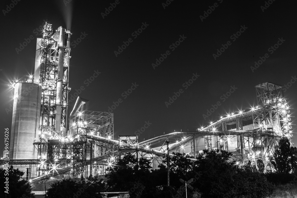 Big plant near the Novorossiysk town, Black Sea coast. Lights glow at night and make feeling of science fiction landscape.