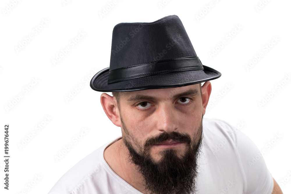 severe bearded man in hat looking at camera isolated on white background. With copy space severe bearded man in hat looking at camera isolated on white background. With copy space