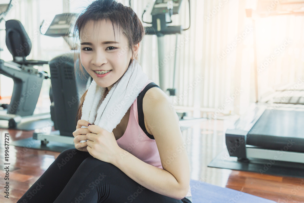 health concept with woman in sport wear relax and break from exercise in fitness center health concept with woman in sport wear relax and break from exercise in fitness center