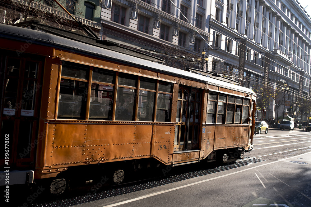 Old Vintage Looking Passenger Commuter Street Car Travels along Busy Market Street in Downtown San Francisco