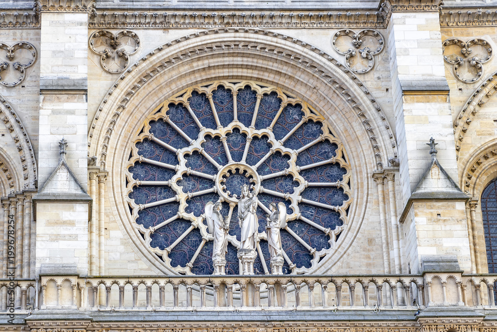 Stained glass window in facade of Notre dame cathedral.  North Rose window at Notre Dame cathedral dates from 1250 and is also 12.9 meters in diameter. Its main theme is the Old Testament