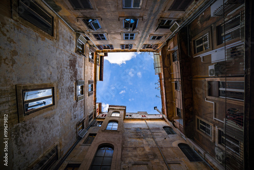 Conceptual image of a overpopulation, ecology, gloominess of urban life in contrast with the beauty of nature, represented here as a small piece of a sky. Shot in Rome, Italy, with 14mm lens in 2017. 