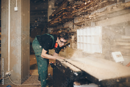 Master carpenter working in his woodwork or workshop. 