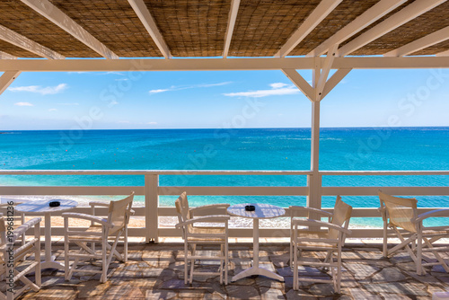 Fototapeta Naklejka Na Ścianę i Meble -  Restaurant terrace overlooking the Aegean Sea, Paleochori Beach, Milos. Cyclades Island, Greece.