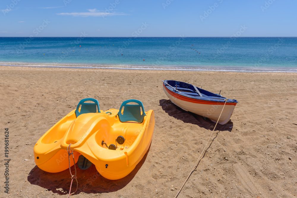 Pedalo with rescue boat on beautiful sandy Paleochori beach on Milos island. Cyclades, Greece. Pedalo with rescue boat on beautiful sandy Paleochori beach on Milos island. Cyclades, Greece.