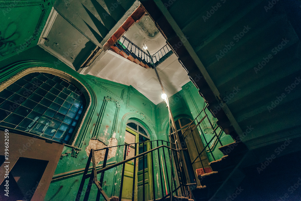 Square spiral staircase in an abandoned house