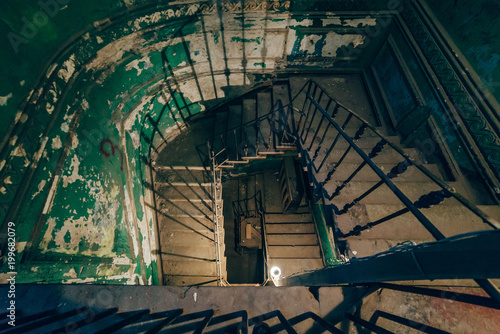 Square spiral staircase in an abandoned house