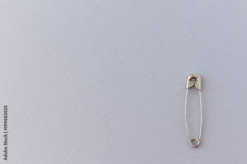 Safety pin on a light background Safety pin on a light background