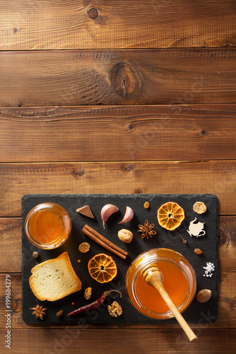 glass jar of honey on wood