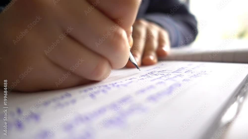 Child hands writing a letter, close up slow motion