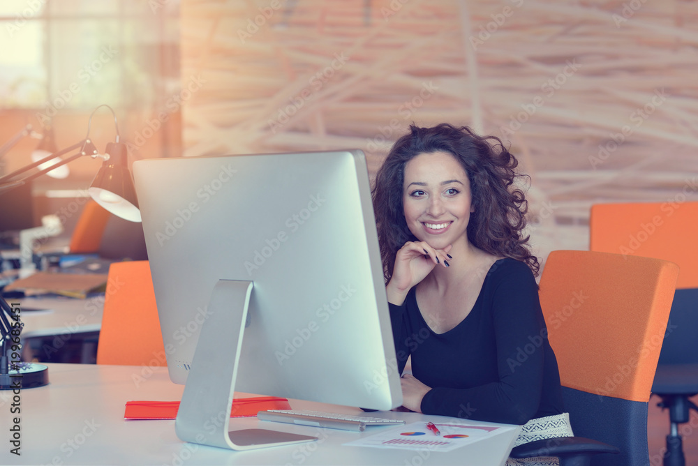 Woman working at computer in an office Woman working at computer in an office