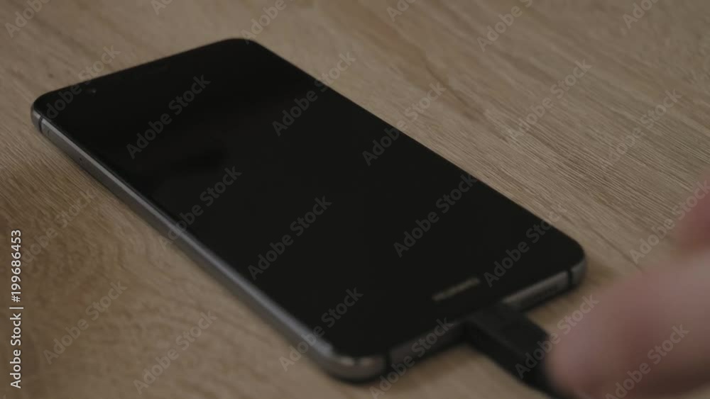 Putting smartphone to charging Putting smartphone to charging
