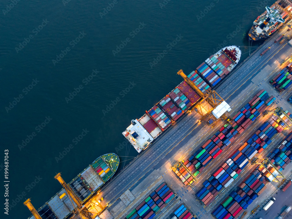 Aerial view of business port with shore crane loading container in container ship in import/export and business logistics with crane and shipping cargo.International transportation concept.