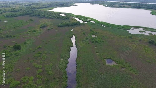 Aerial shot of the Dnipro basin covered with lakes, inflows and greenery photo