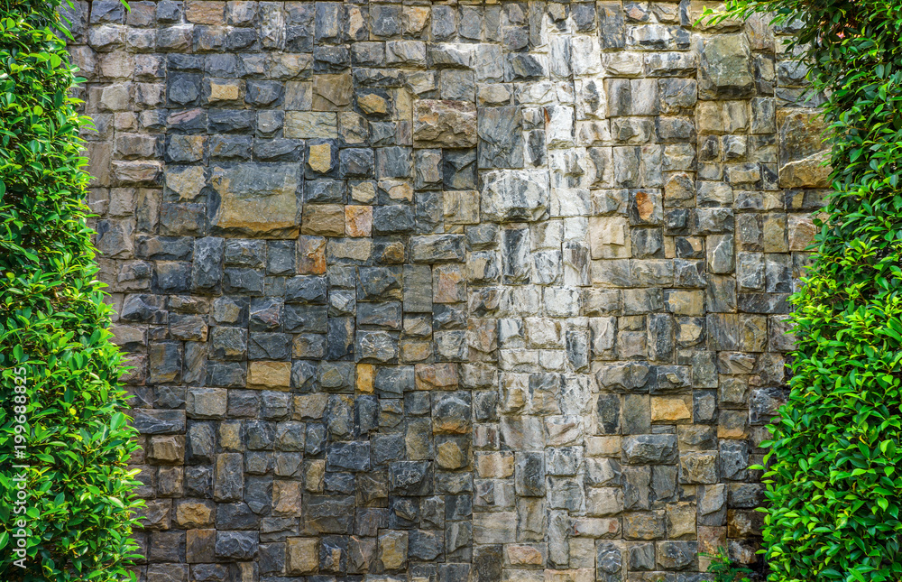 Stone wall with trees at rim of frame. The exterior decoration in garden. Stone wall with trees at rim of frame. The exterior decoration in garden.