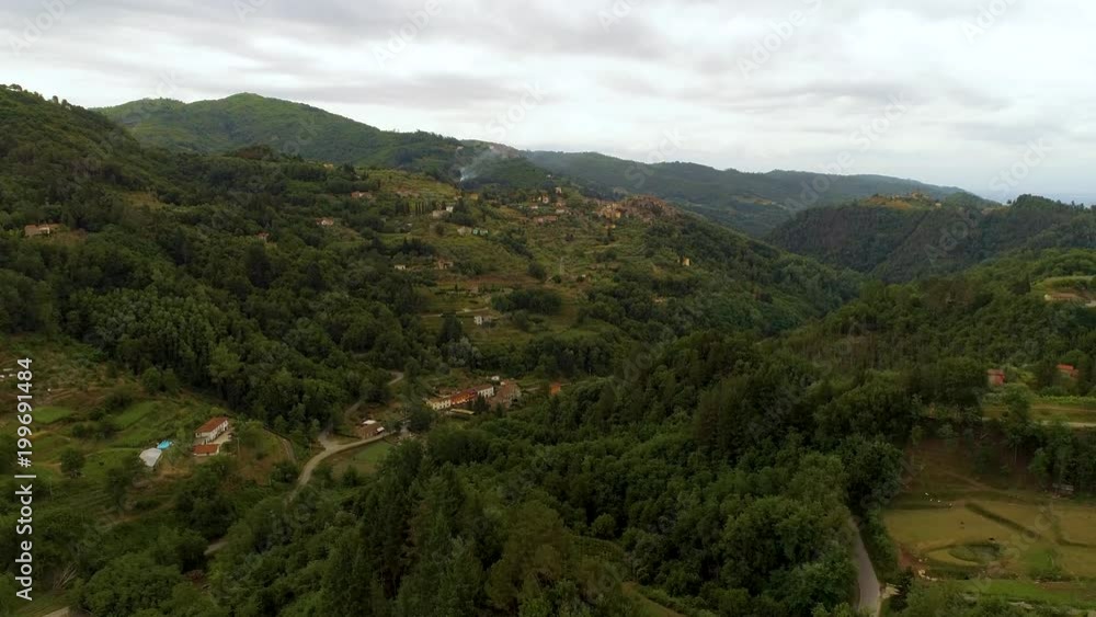 Aerial over the mountains and villages in Tuscany region of Italy. Aerial over the mountains and villages in Tuscany region of Italy.