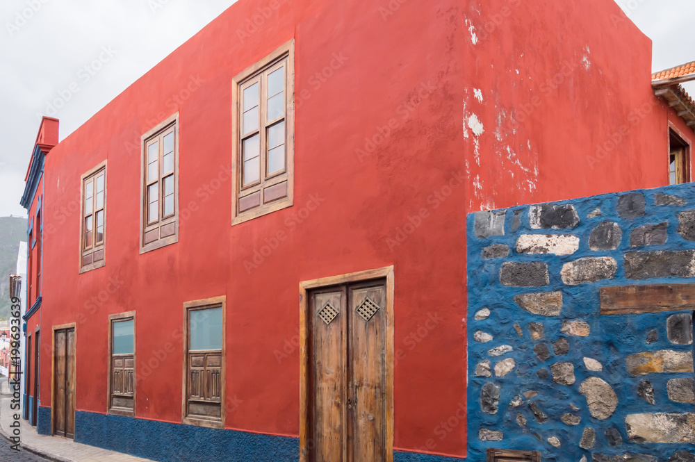 A house with red facade of Canarian architecture on the island of Tenerife in Spain