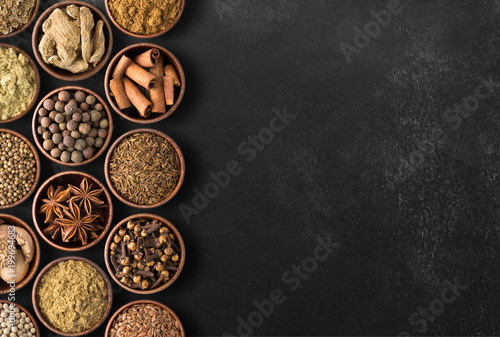 Spices  over black table background. Top view of seasoning with free space