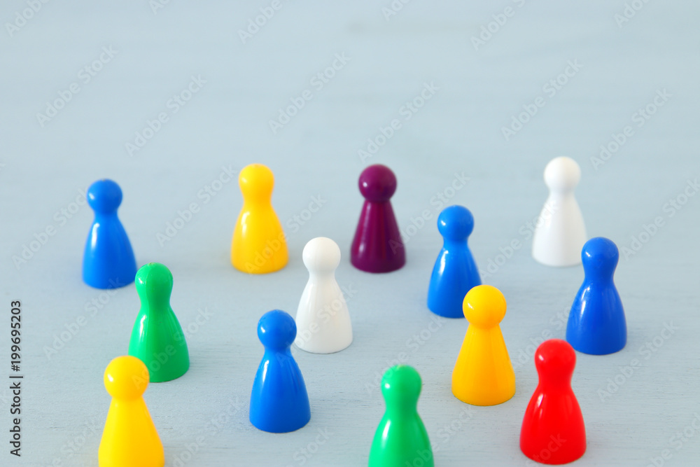 image of colorful game figures over wooden table ,human resources and management concept. image of colorful game figures over wooden table ,human resources and management concept.
