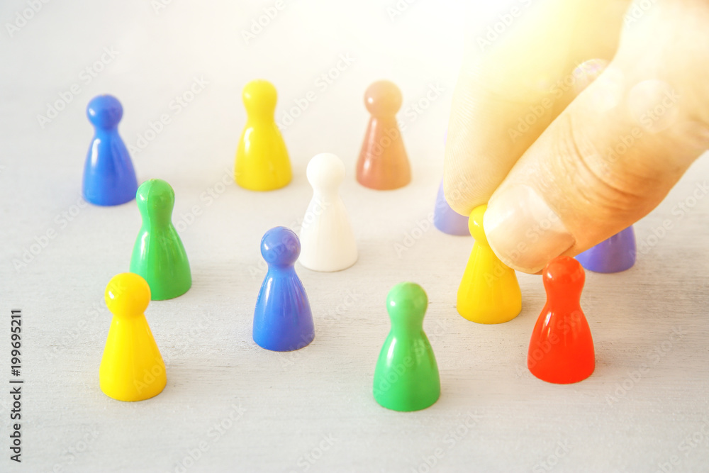image of colorful game figures over wooden table ,human resources and management concept. image of colorful game figures over wooden table ,human resources and management concept.
