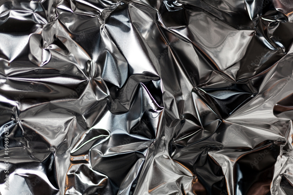 Full frame take of a sheeT of crumpled silver aluminum foil Full frame take of a sheeT of crumpled silver aluminum foil
