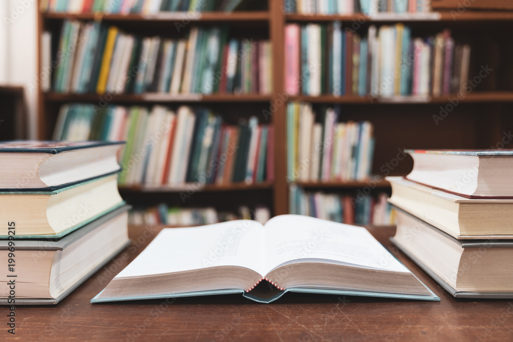 Education learning concept with opening book or textbook in old library, Book in library with old open textbook, Stack piles of literature text academic archive on reading desk in school class room Education learning concept with opening book or textbook in old library, Book in library with old open textbook, Stack piles of literature text academic archive on reading desk in school class room