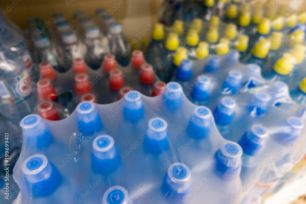 PET Bottles. Image of many plastic bottles with water in a shop. plastic bottles with drinking water top view. PET Bottles. Image of many plastic bottles with water in a shop. plastic bottles with drinking water top view.