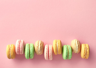 Colorful french macarons on pink background
