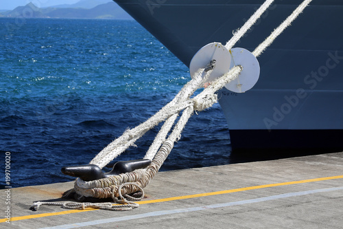 mooring lines with rat guards attached to cleat on pier, Lesser Antillies, Caribbean photo