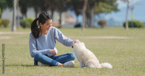 Woman play with her dog at outdoor park
