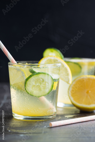 Sassy detox water with lemons, cucumbers and ginger. Healthy breakfast.