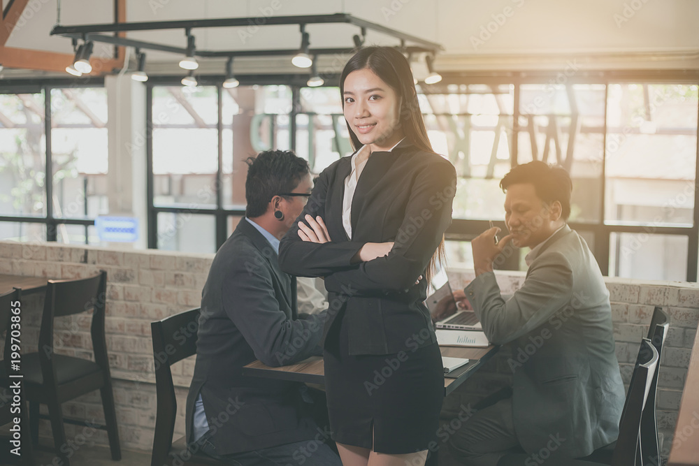 Fototapeta premium Portrait of a business woman and colleagues background