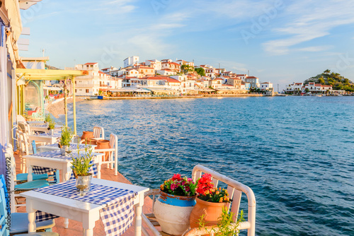 Fototapeta Naklejka Na Ścianę i Meble -  the interior of a Greek traditional tavern by the sea, decorated with flowers, in the popular tourist village of Kokkari, Samos island, Greece