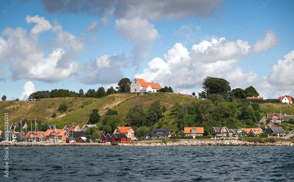 Coastal village with a church on the top of the hill. Swedish summer. Sail around the Baltic.