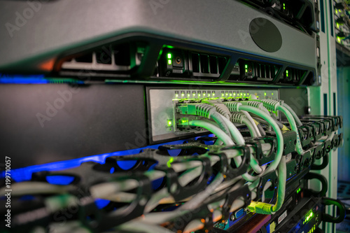Servers and switches are located in the server room of the data center. Connecting the Internet wires with computer equipment. Cabling in the server cabinet.