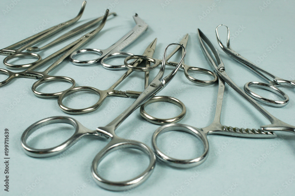 Medical surgical Instruments on blue background. Selective focus Medical surgical Instruments on blue background. Selective focus