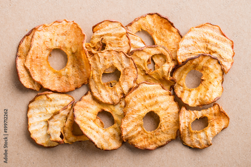 Healthy snack. Tasty dried apple and pear rings chips on light background. Top view, flat lay Healthy snack. Tasty dried apple and pear rings chips on light background. Top view, flat lay