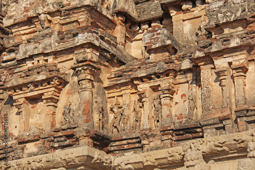 Hazara Rama Temple in Hampi, Karnataka, India. Unesco World Heritage Site. Carving stone ancient background. Fragment of red brick terracotta. Beige ancient antique background photo